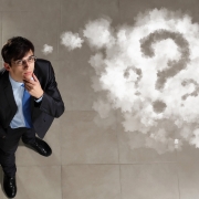 Top view of young businessman making decision, thought cloud above head with a question mark