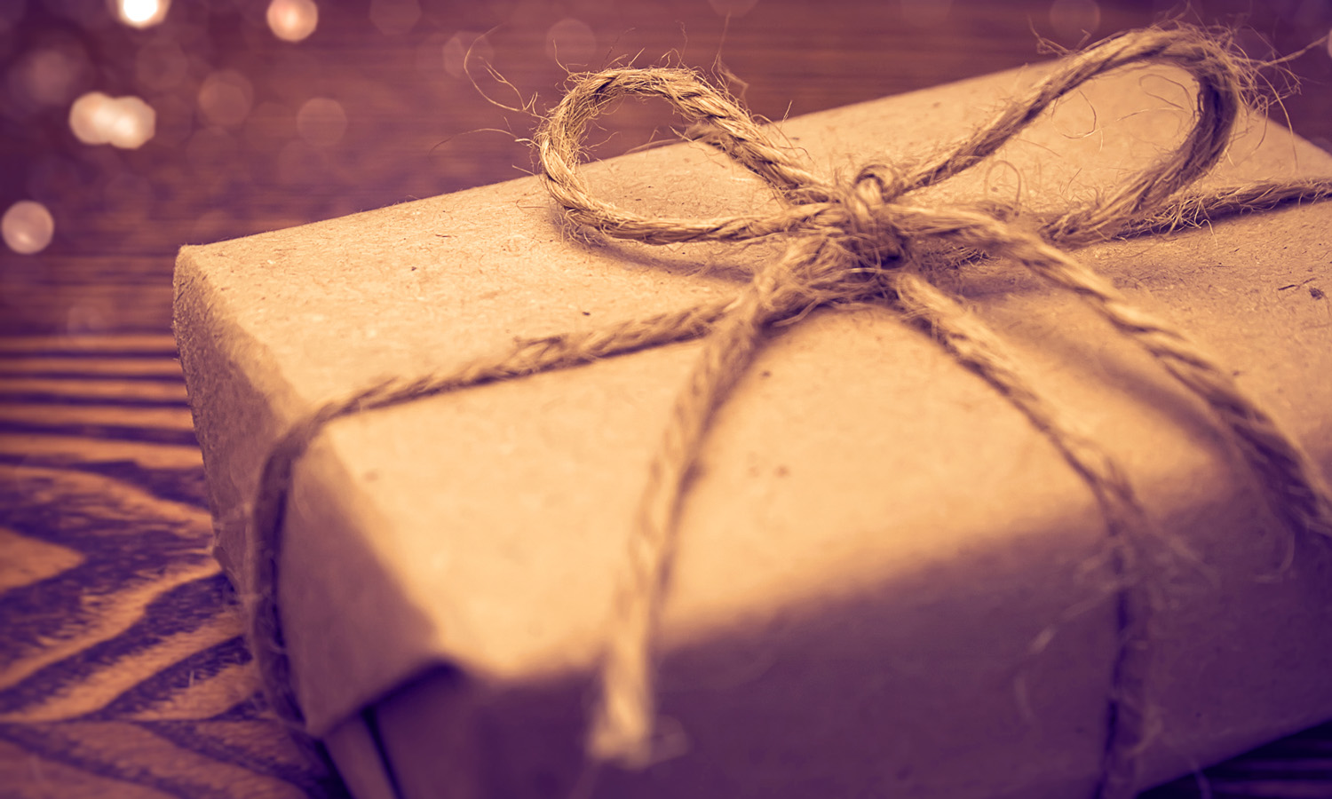 Gift wrapped in paper on the wooden background