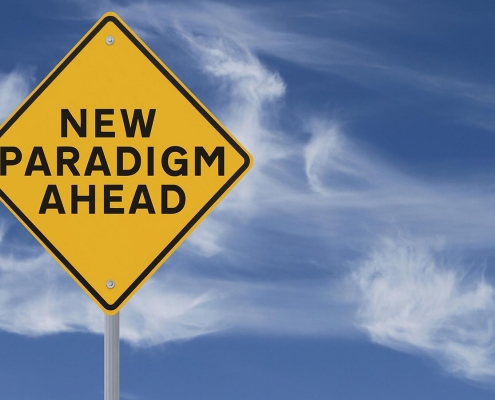 Conceptual road sign on change and paradigms (against a dramatic sky background)