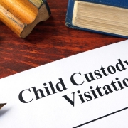 Child Custody and Visitation written on a paper and a book