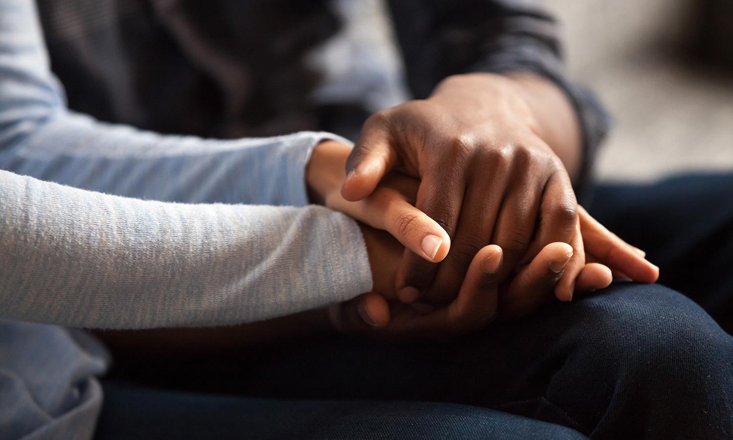 Why I Mediate (Close up black woman and man in love sitting on couch two people holding hands)